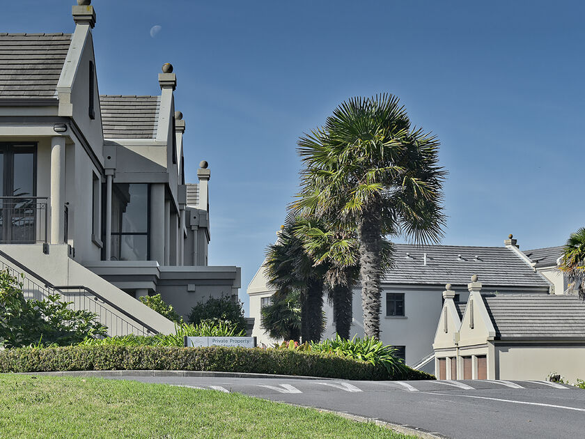 Private residential property with landscaped gardens and palm trees